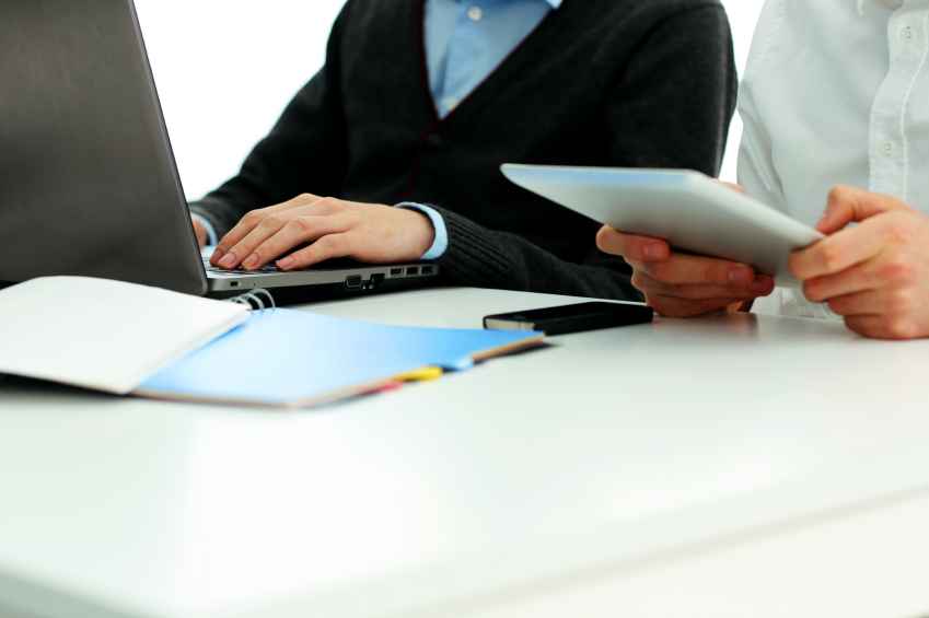 Employees working on a latop and tablet